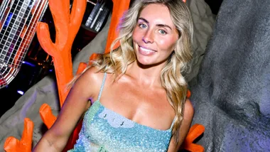 A blonde woman smiling.