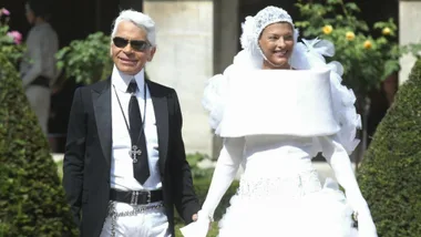 Karl Lagerfeld and Linda Evangelista at the chanel couture show in 2003. Evangalista plays the bride in a white dress and head wrap