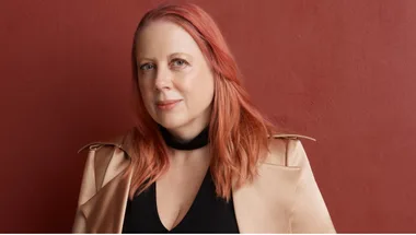 Annabel Daniel OAM against a red background