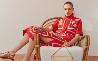 woman wearing a red printed dress sitting