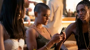 tea app leak: woman holds her phone looking concerned