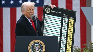 S President Donald Trump delivers remarks on reciprocal tariffs as US Secretary of Commerce Howard Lutnick holds a chart during an event in the Rose Garden entitled "Make America Wealthy Again" at the White House in Washington, DC, on April 2, 2025.